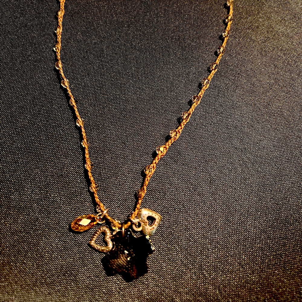 Brighton brown cord necklace with beads sewn in . Brown cross pendant